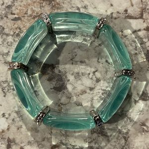 Curved Clear Resin Section Stretch Bracelet with Rhinestone Separators.